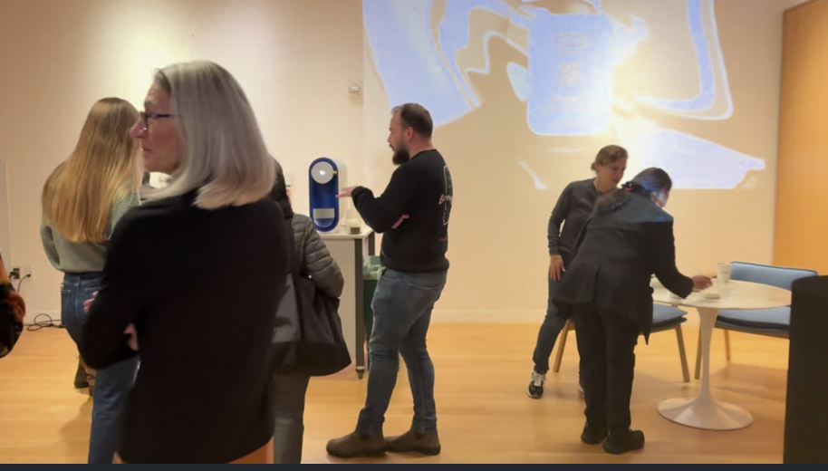 Visitors gathering at a community gallery opening downtown